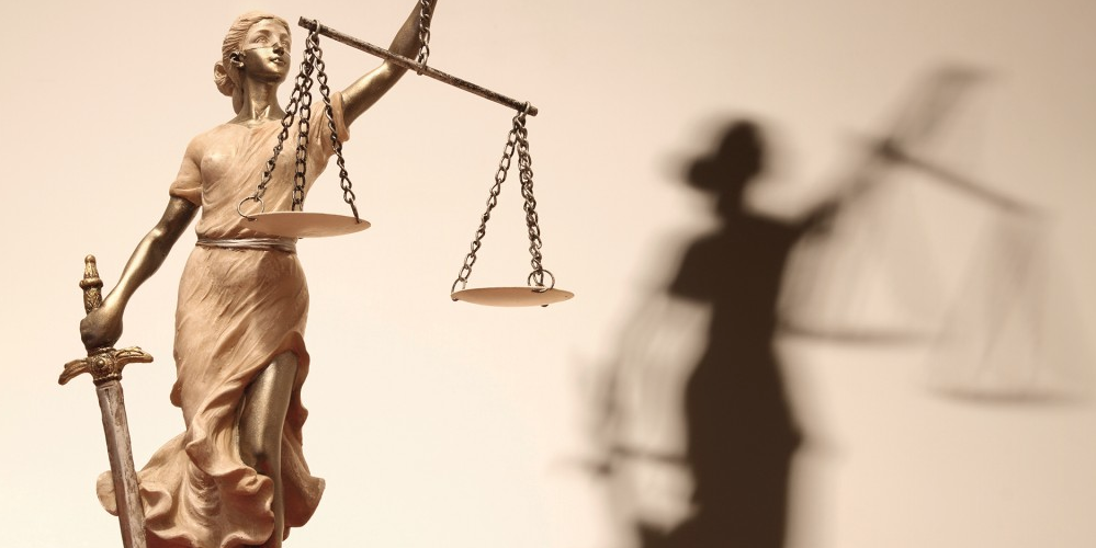 figure of woman hold sword and balance of justice